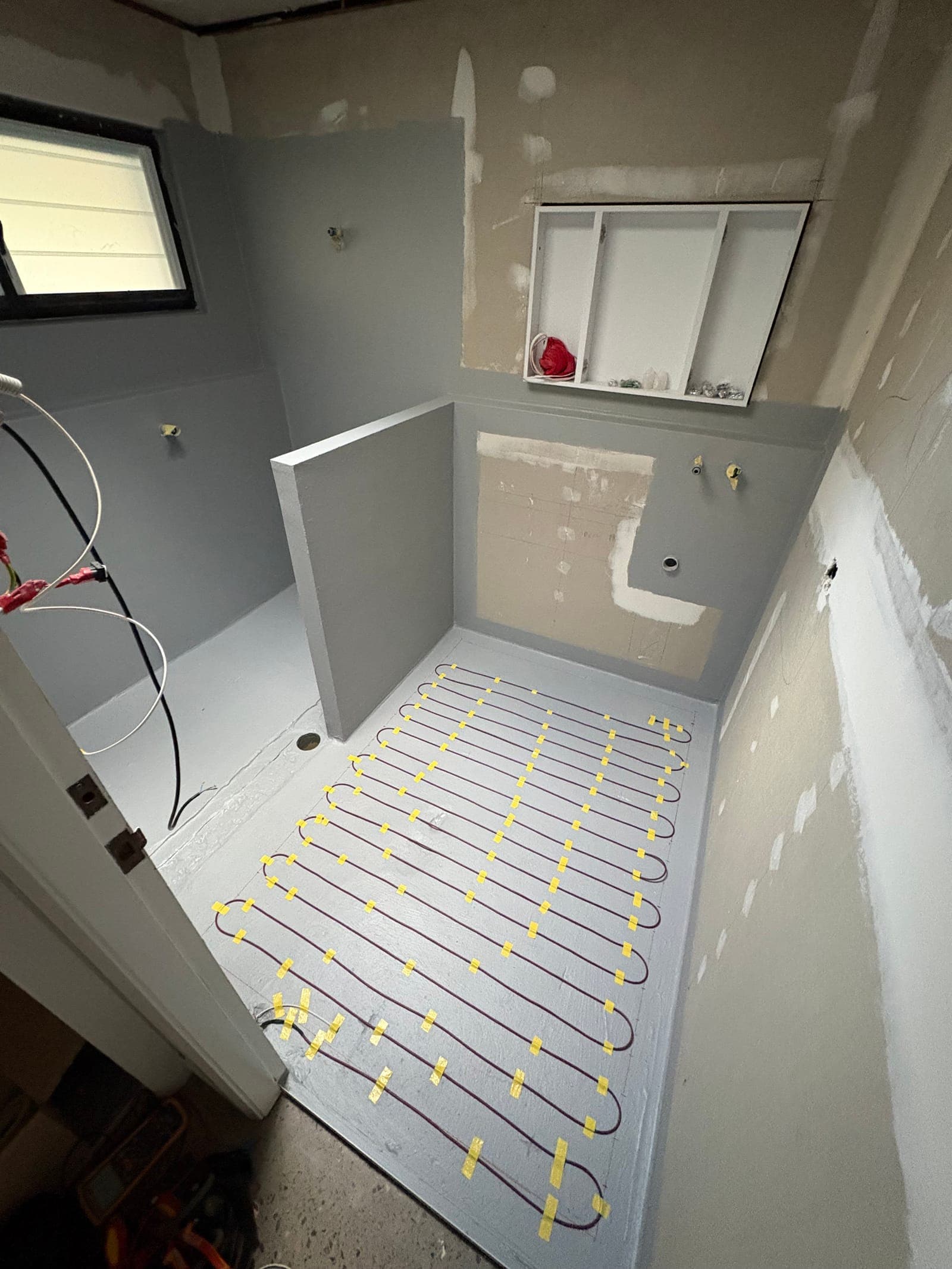 In-screed electric underfloor heating installed in bathroom renovation