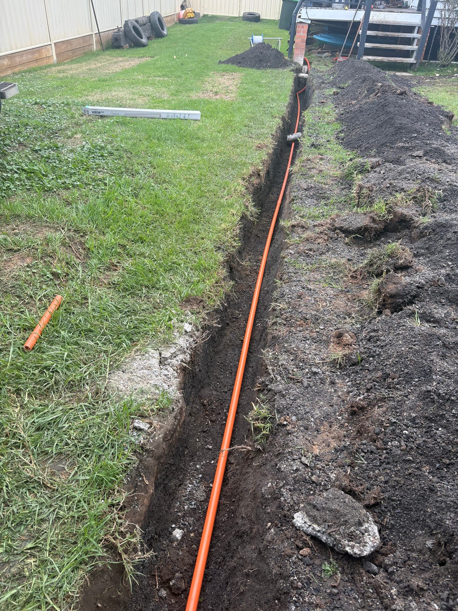 Underground PVC conduit laid in trench for shed power supply